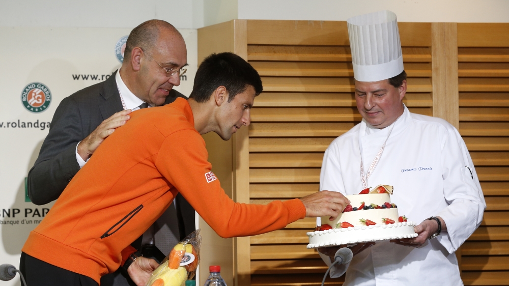 Djokovic celebrated his 28th birthday by eating a gluten-free cake at this year's French Open [Getty Images]