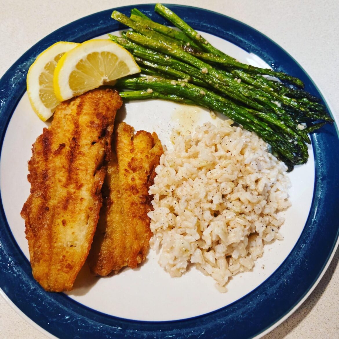 Pan-fried Dover sole, brown rice, and roasted asparagus with homemade vinaigrette.