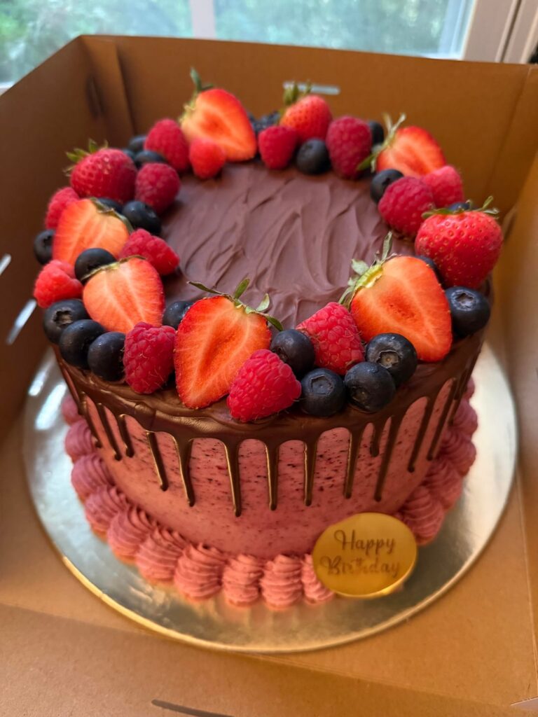 My latest bake: chocolate cake + triple berry mousse + berry buttercream + ganache drip + fresh berries✨