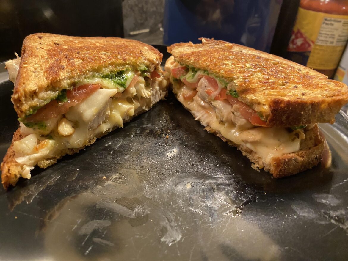Sautéed Chicken Breast, Homemade Pesto, Sliced Tomato, Hellmann’s Mayo, Buttered Multigrain on the Griddle