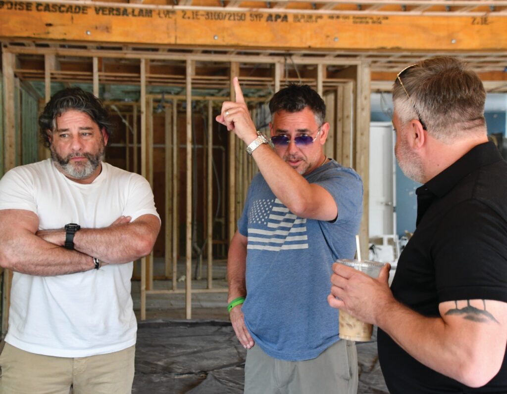Owners Jeff Merlino, from left, Anthony Quetta and Tony Lanni inspect the construction work being done at 14 Narragansett Ave. The building, which most recently housed Curiosity and Co. and before that Jamestown Fish, will be returning to its restaurant roots when they open Crudo Oyster Bar and Coastal Italian Kitchen. The three men’s plan is to have the outside portion of the restaurant, below, open sometime in September while the inside is being completed. PHOTO BY ANDREA VON HOHENLEITEN