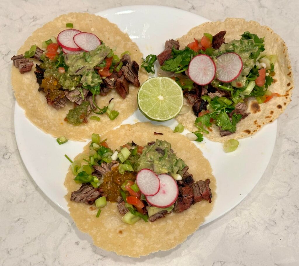 Carne Asada tacos with salsas and guacamole [homemade]