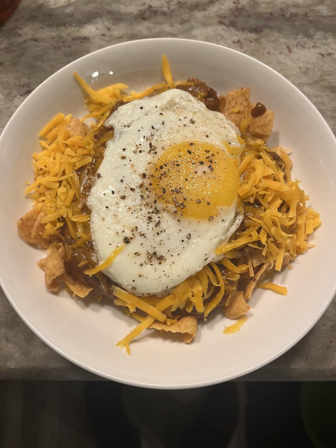 I was a bit baked and used leftover chili to make frito pie added a sunny side up egg.