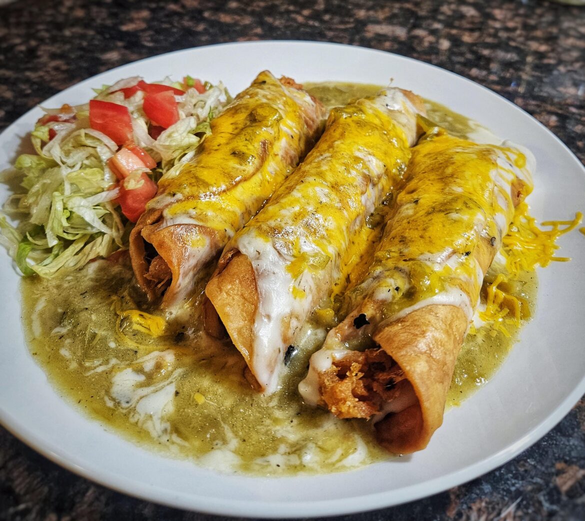 Inspired by a dish I ate at Del's in Tucumcari, NM last weekend. This is chicken crispitos. A chicken taquito in a flour tortilla, with green bell pepper and cheese. Smothered in cream gravy and green chile.