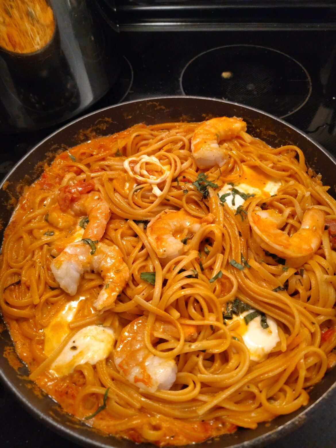 Linguine with a creamy sauce, mozzarella and shrimp. Homemade sauce with tomato, onion, garlic and basil - local shrimp. Delish.
