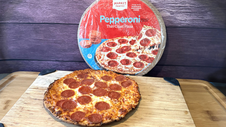 market pantry pepperoni pizza on cutting board with packaging