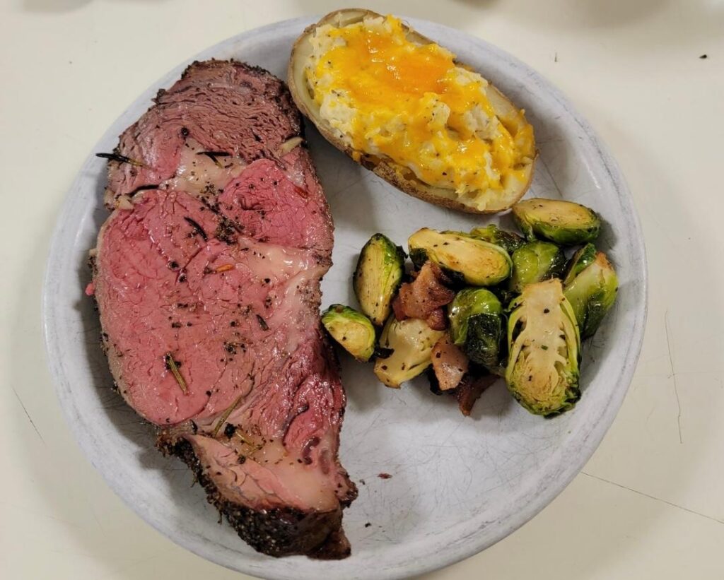 Prime rib, double baked potato, and a side of brussel sprouts