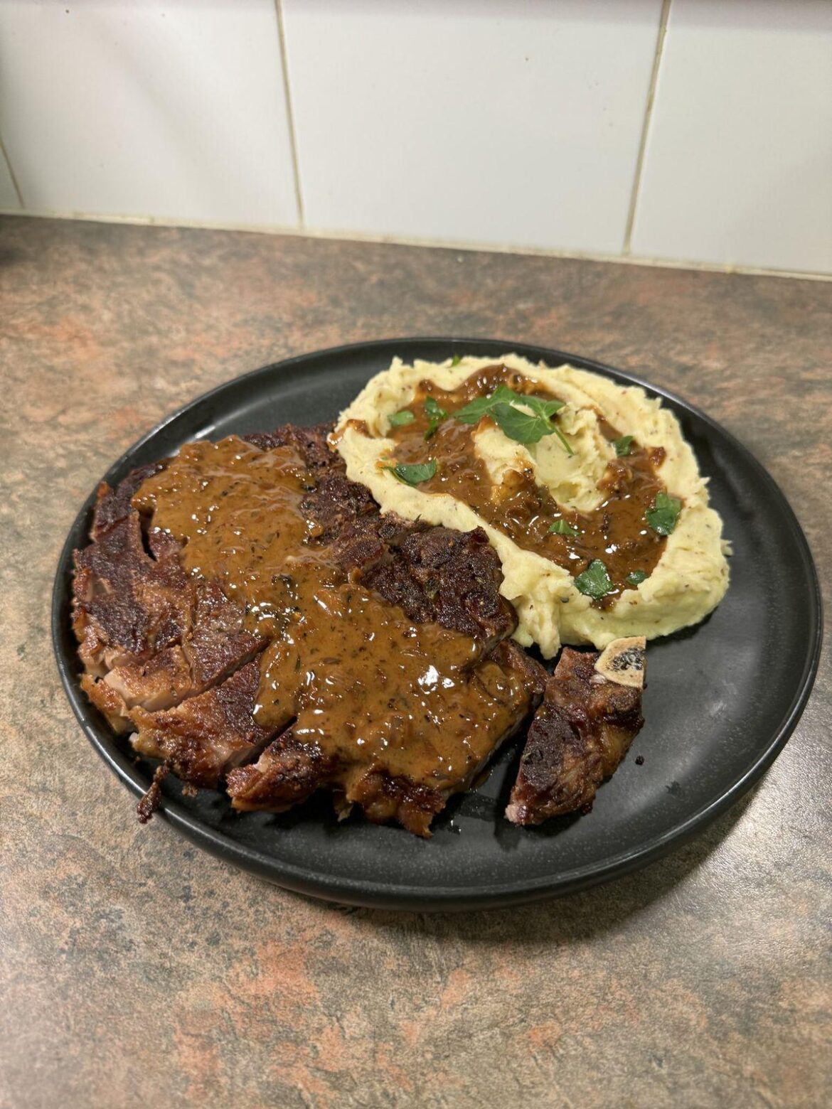 [Homemade] tender beef brisket drizzled with gravy, served alongside creamy mashed potatoes