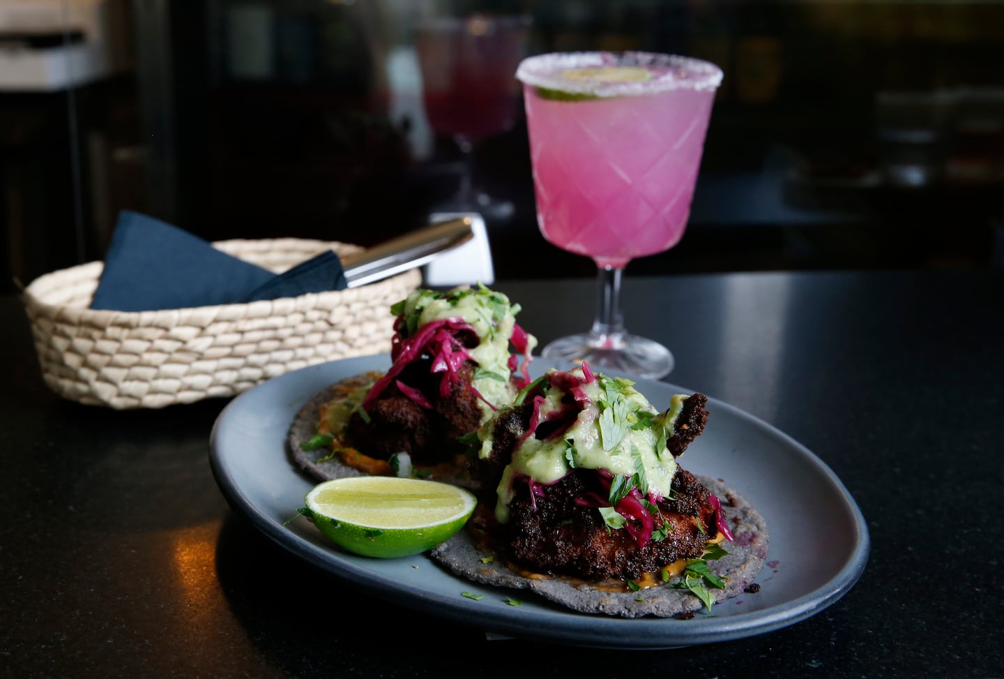 Crispy shrimp tacos with a prickly pear margarita at Barra. A new fall menu is coming soon.
