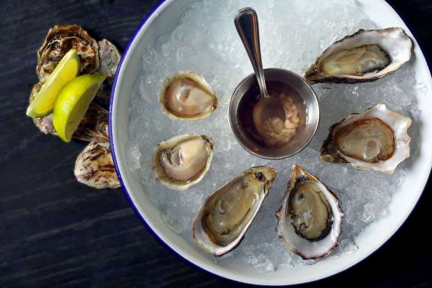 Counterclockwise from left, the selection of daily oysters include Totten...