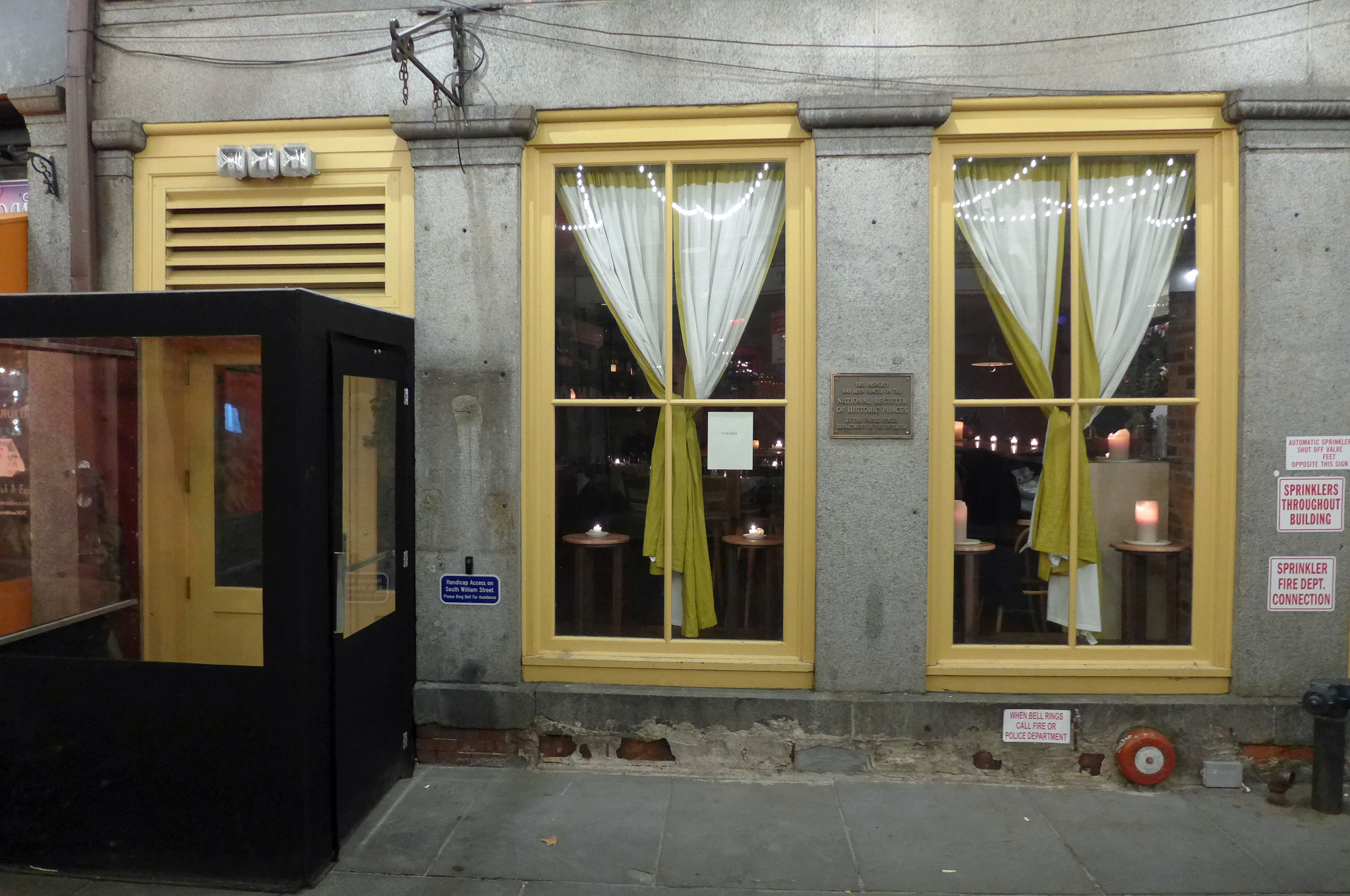 A gray facade with deep yellow window frames.