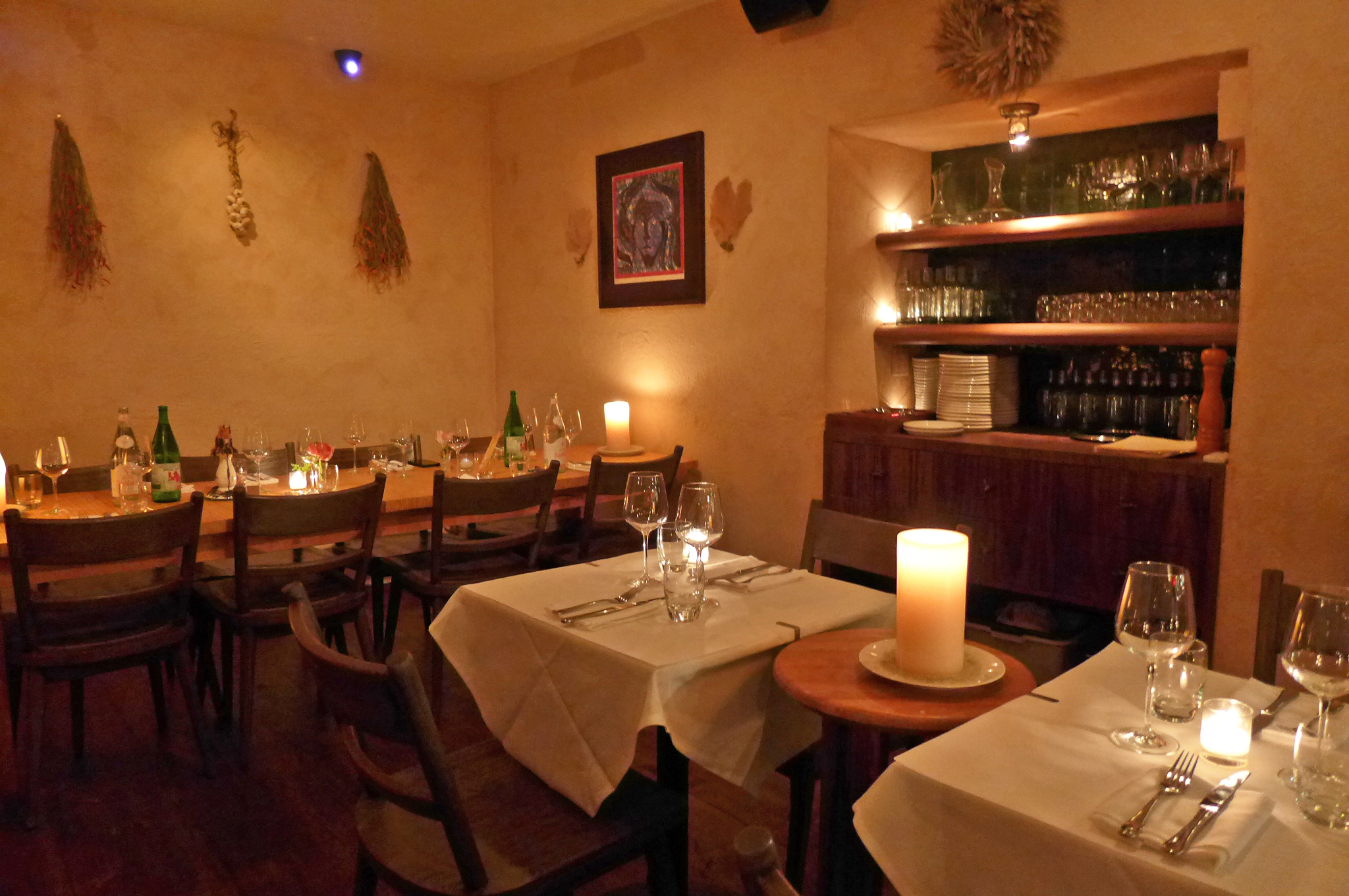 A room with herbs  and garlic hung on the walls.