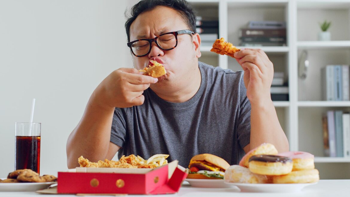 Fat Asian Man Eating Junk Food
