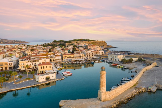 Aerial view of the old Venetian harbour and lighthouse at dawn, Rethymno, Crete island, Greecee