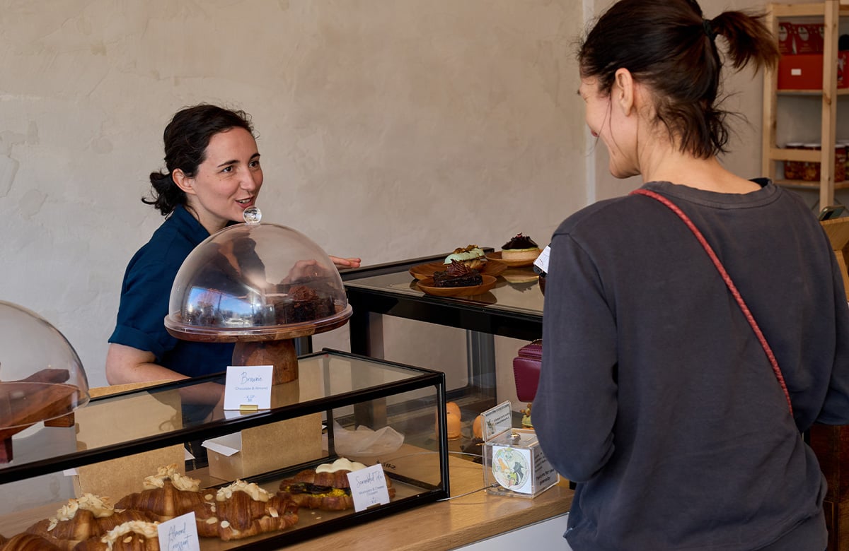 Laura serves a customer at W.H.I.P Patisserie