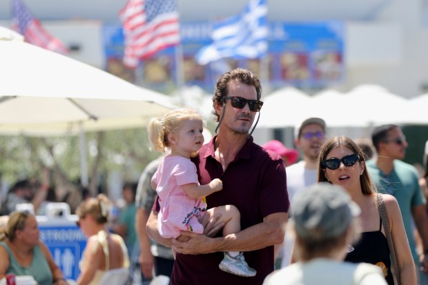 Attendees stroll through the Long Beach Greek Festival on Sunday,...