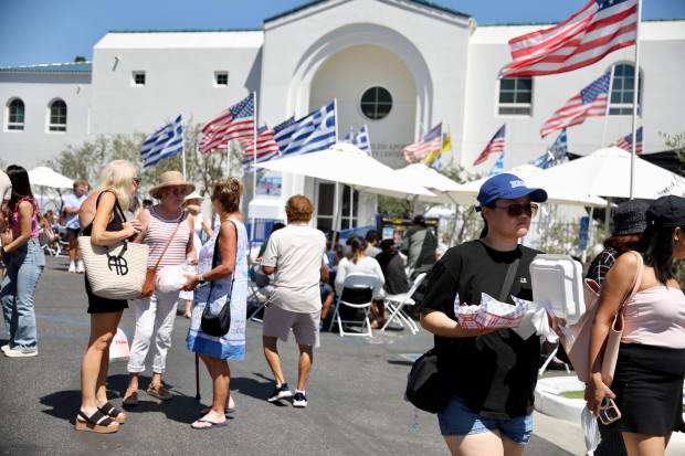Attendees stroll through the Long Beach Greek Festival on Sunday,...