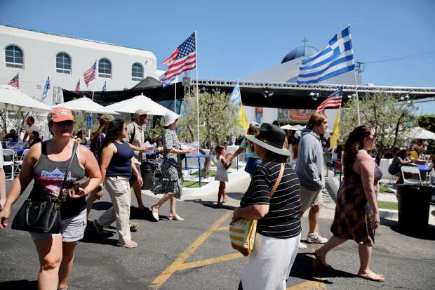 Attendees stroll through the Long Beach Greek Festival on Sunday,...