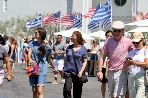 Attendees stroll through the Long Beach Greek Festival on Sunday,...
