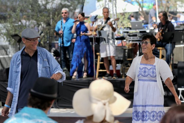 Attendees dance to a live band at the Long Beach...