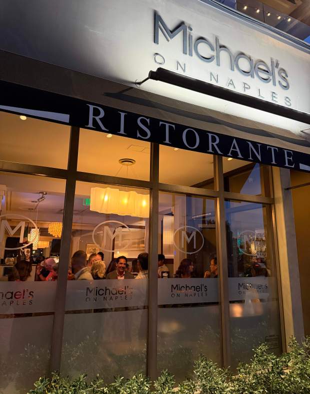 Diners wait for a table as at Michael’s on Naples...