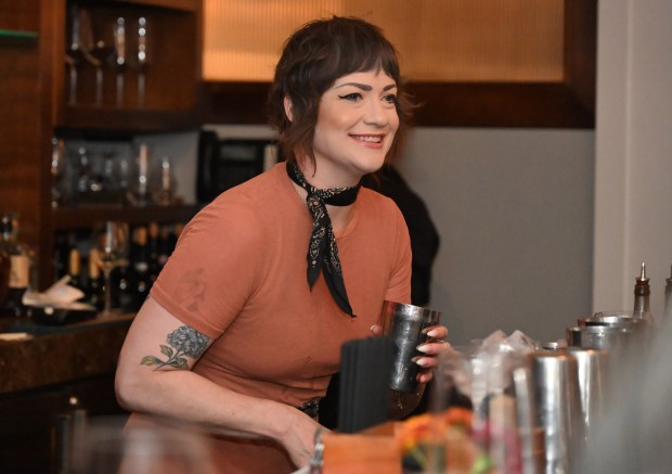 Jocelyn Jolley, a long time employee laughs with customers at...