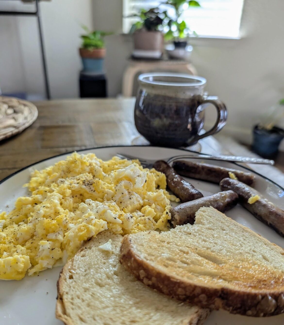 Sourdough toast, link sausage, and a big pile of scrabbled eggs.