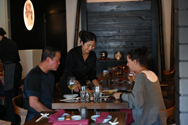 Yuki Nomura, MaruJun's manager, serves customers at the San Rafael...