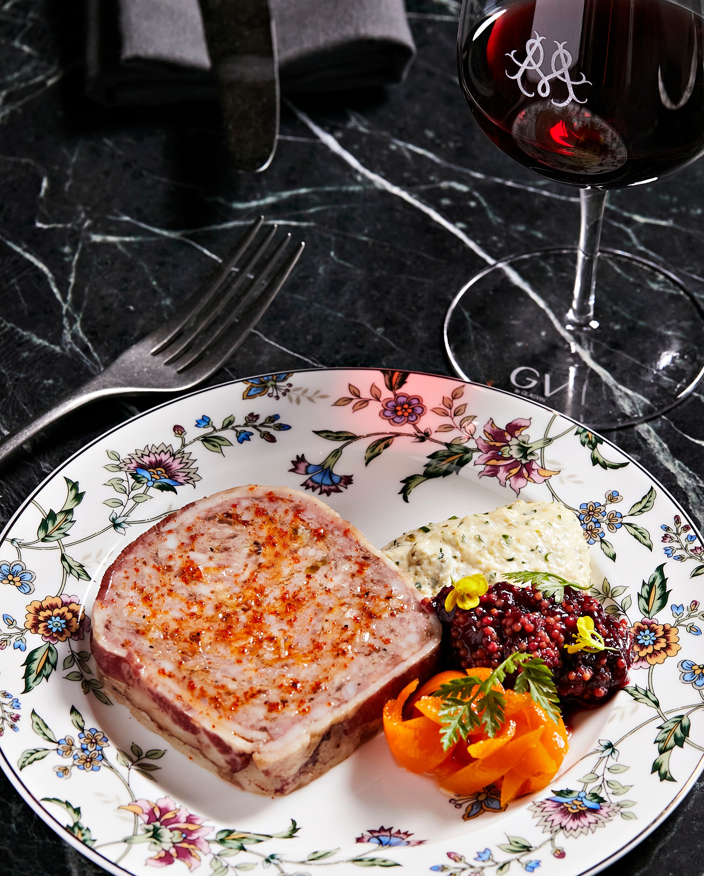 Pate arrives on a vintage plate alongside Maison-branded glassware.