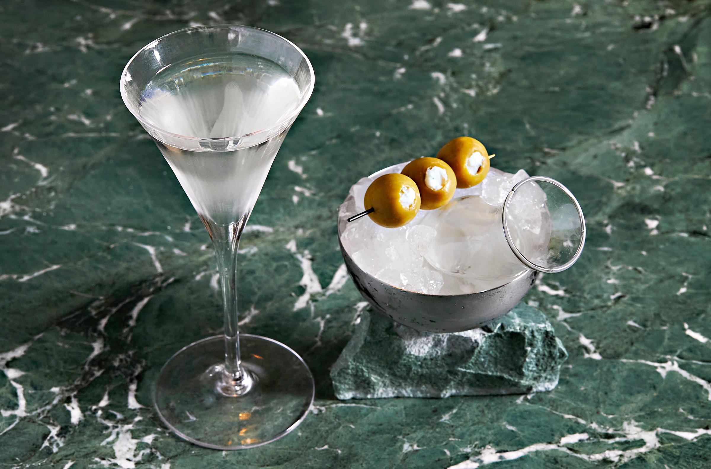 Martinis arrive with a trio of olives.