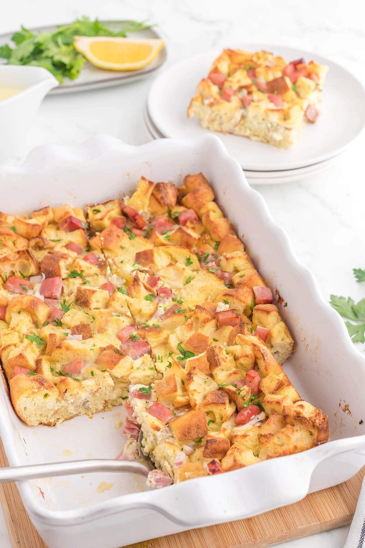 These 35 Scrumptious Make Ahead Brunch Casseroles will make your life over the holidays so much easier. Plus, everyone will be delighted with any one of these casseroles for the holidays. Eggs benedict casserole in dish.