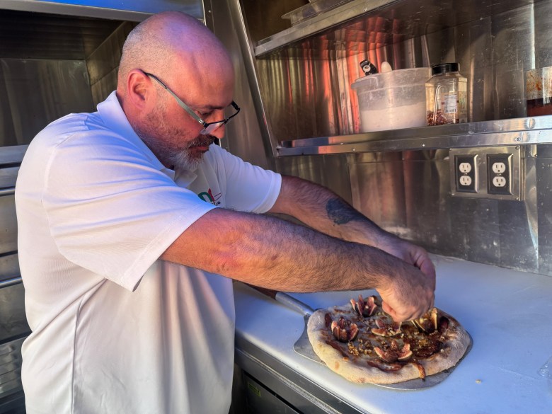 Samuele Polverosi finishing the fig and salami pizza. Photo by Robert Eliason.