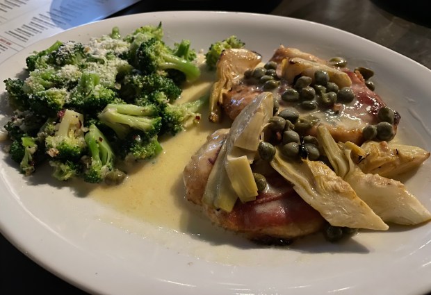 chicken topped with artichokes and capers served with a side of broccoli