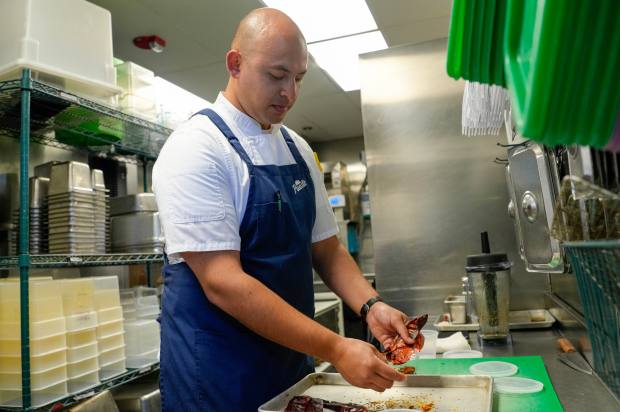 Casillas prepares the chiles before adding them to the marinade....