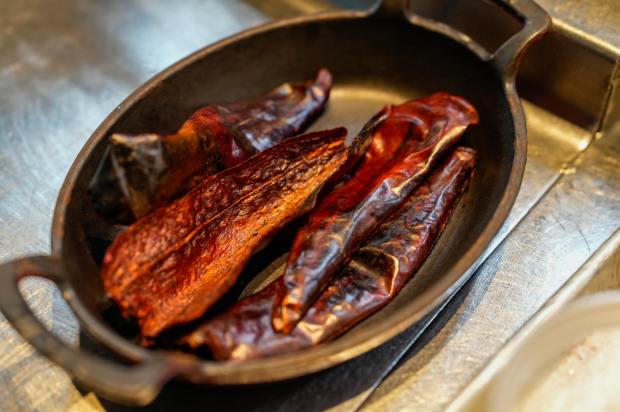Guajillo chiles, destemmed and seeded, are toasted to a deep...