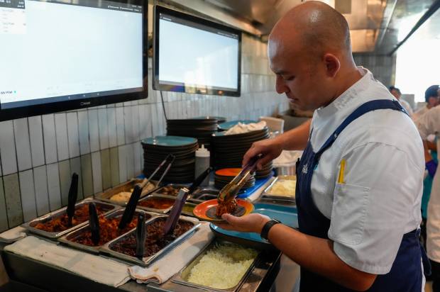 Assembling the Cochinita Pibil Taco. (Alejandro Tamayo / The San...