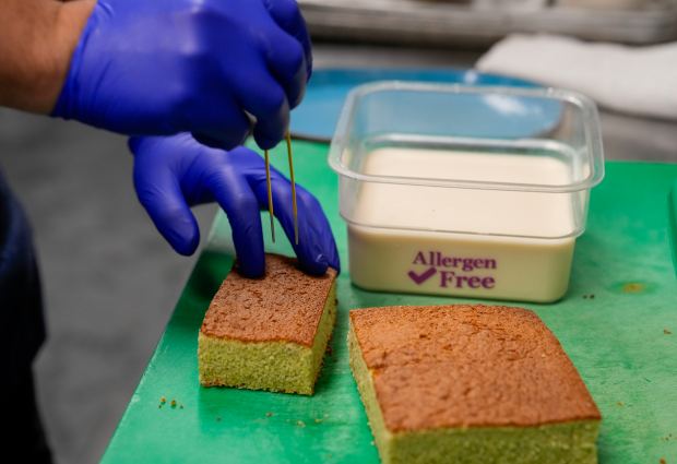 Casillas pokes holes into the cake slices before dipping them...