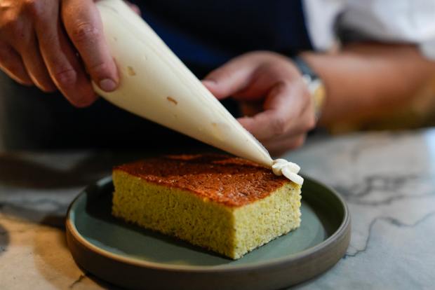 Casillas uses a piping bag to add stripes of passion...