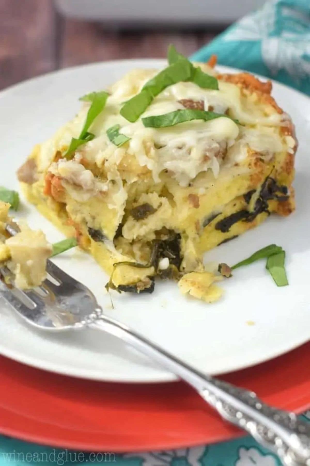 These 35 Scrumptious Make Ahead Brunch Casseroles will make your life over the holidays so much easier. Plus, everyone will be delighted with any one of these casseroles for the holidays. Spinach artichoke strata on plate.