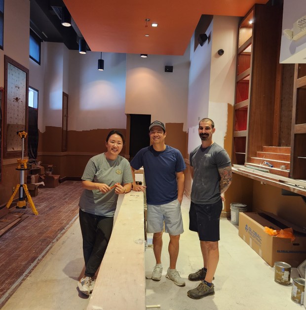 James Beard finalists Jason and Sue Chin of Orlando's Good Salt Restaurant Group and Chef/Partner Michael Cooper scope out the paint progress at their newest venue, Osteria Ester, slated to open next month in Orlando's Thornton Park neighborhood. (Courtesy Good Salt Restaurant Group)