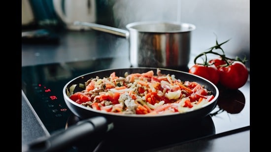 They can be noisy, and they only work with certain grades of metal, but induction cooktops have come a long way. They don't even cost much more than a gas range today. (Shutterstock)