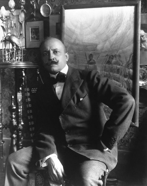 a black and white photo of a man in a suit.
