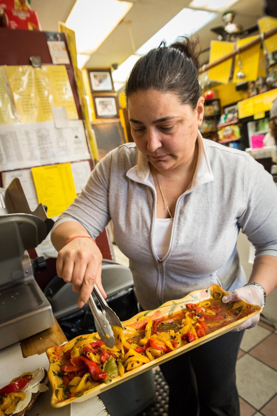 Angela Occhipinti, the owner of Mamma Rosa's Cucina, makes a sandwich in the kitchen. Angela Occhipinti, the owner of Mamma Rosa's Cucina, makes a sandwich in the kitchen.