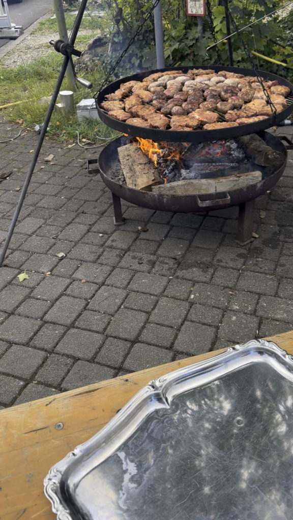 German fire brigade cooking meat for their village bbq.