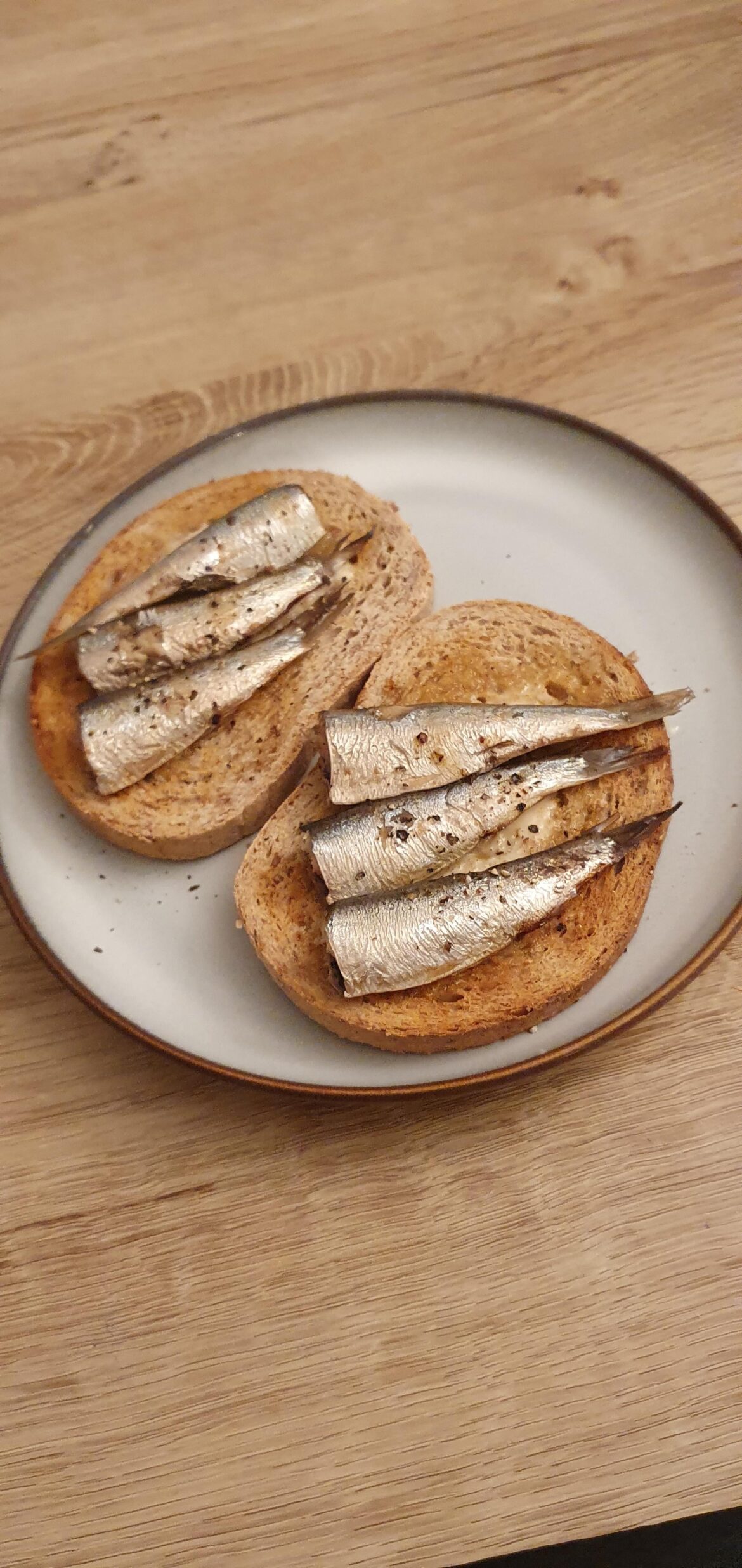 Simple lunch of sardines in olive oil, black pepper and tabasco on toast.