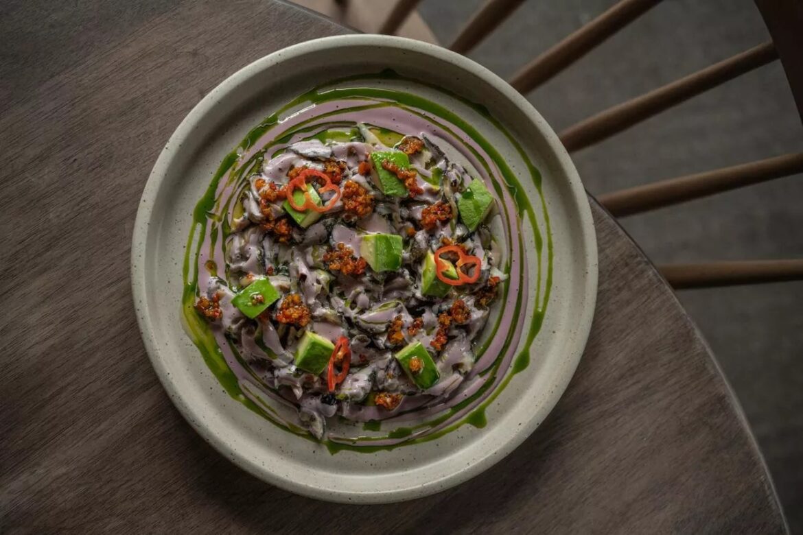 10 Most Anticipated Denver Restaurant Openings Fall 2025 clam dish on a plate with sauces