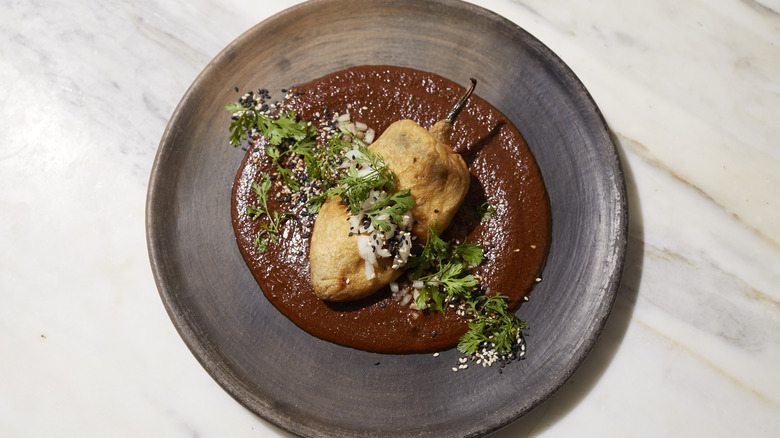 Chiles rellenos on brown plate