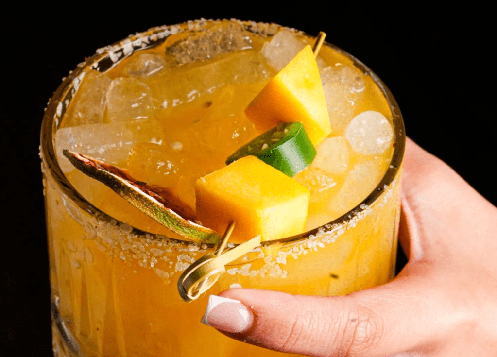 a yellow drink and a hand