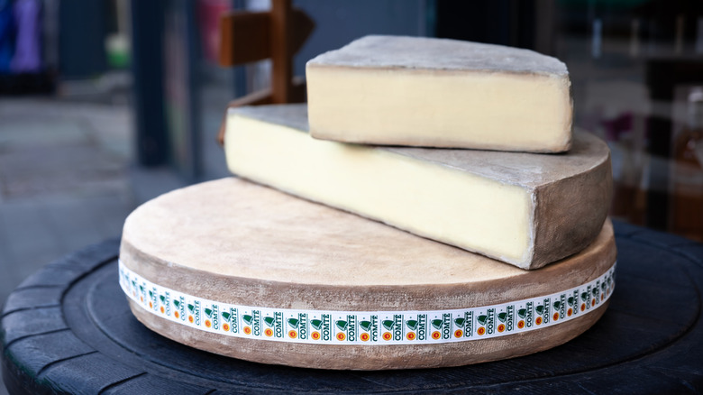 wheel of comte cheese sliced