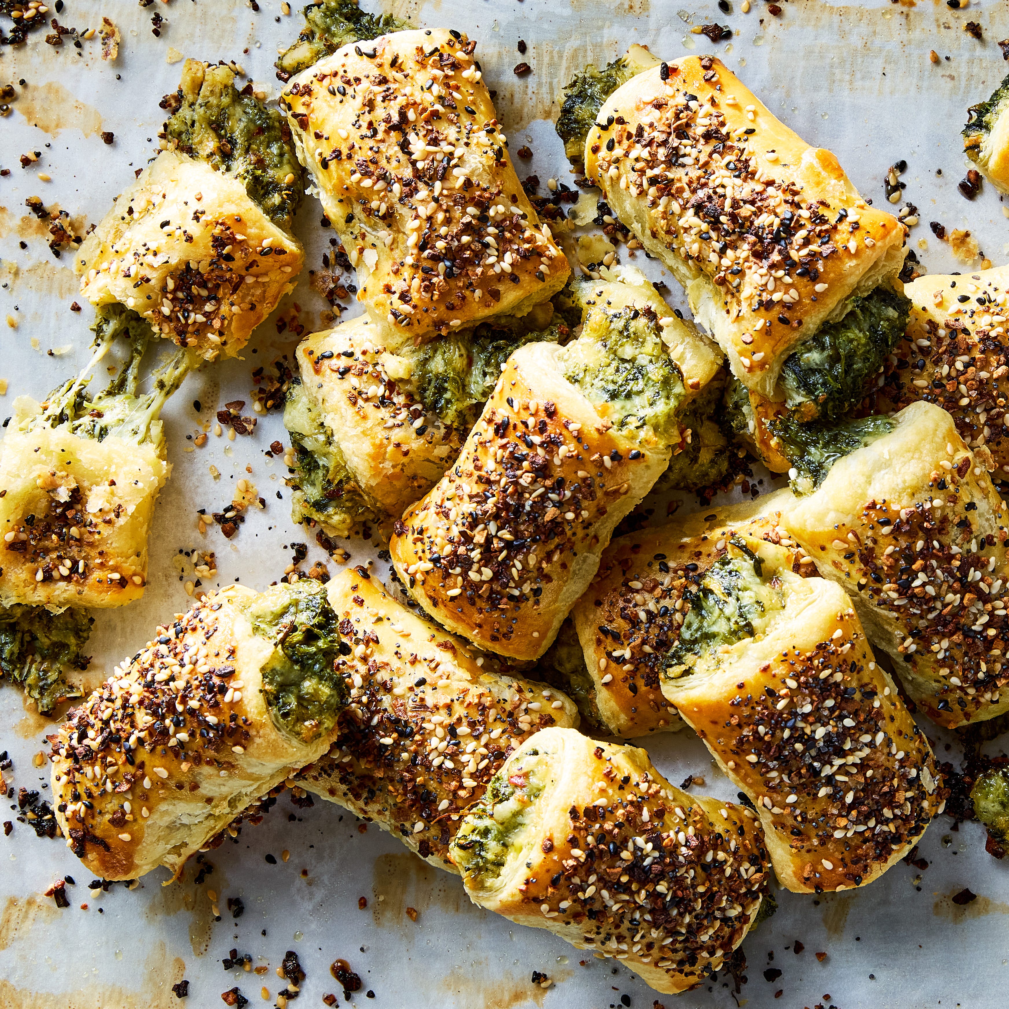chopped spinach, marinated artichokes, and three types of cheese rolled into flaky puff pastry, topped with everything bagel seasoning, and baked until golden brown